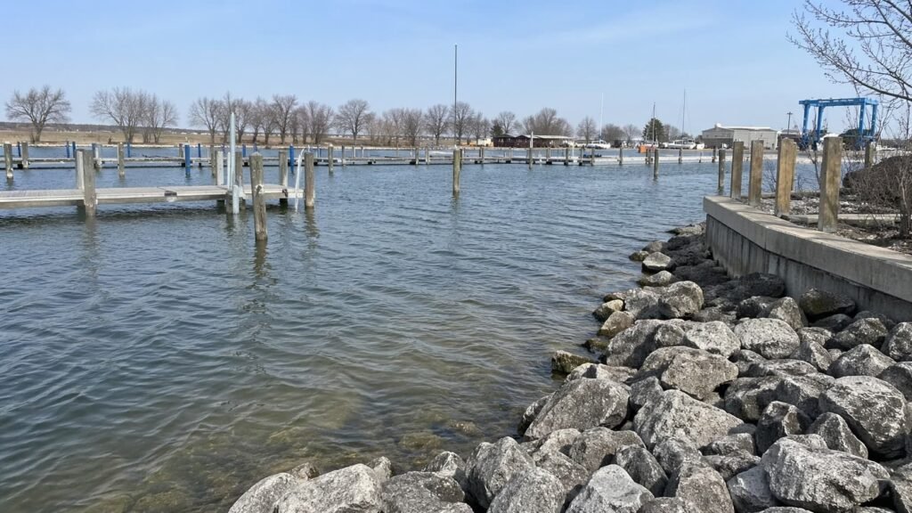 Michigan harbor edge with riprap, pilings, and channel structure that can hold carp.