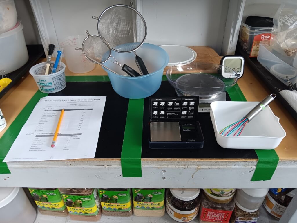 Carp bait ingredients, boilies, pellets, corn, tiger nuts, and liquids arranged on a bait bench for a practical carp bait guide